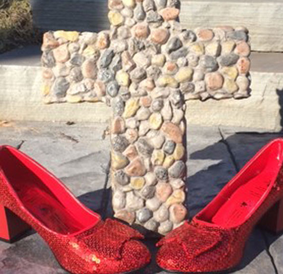 Ruby slippers in front of a cross